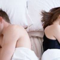 0702 couple in bed lying back to back sm copia